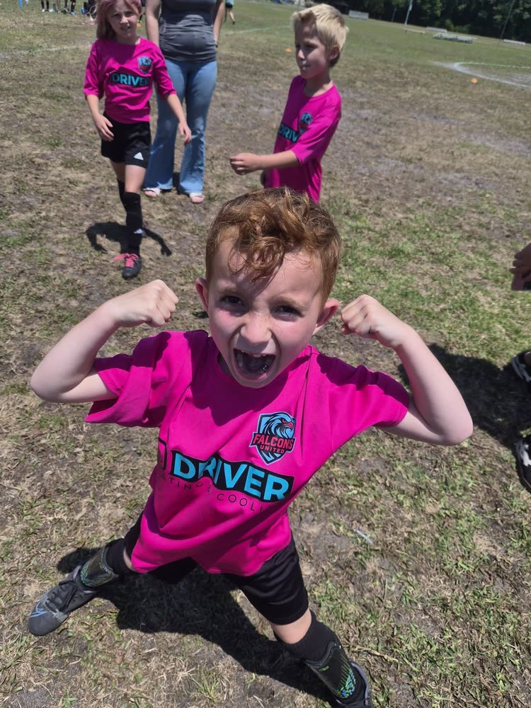 A young Falcons United player flexing